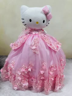 a hello kitty stuffed animal in a pink dress with flowers on it's skirt