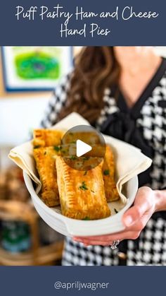 a woman holding a bowl with food in it and the words puff pastry ham and cheese hand pies