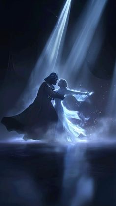 two people are dancing in the dark with light coming from their heads and lights shining down on them