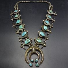 Circa 1930s OLD PAWN NAVAJO SQUASH BLOSSOM NECKLACE  CAST DOUBLE NAJA and TURQUOISE DESCRIPTION:  This exquisite museum quality necklace will be a valuable addition to your collection of the very finest Southwestern and Native American jewelry. MEASUREMENTS:  Necklace measures 25" end to end Naja measures 2 1/4" x 2 1/4" Beads are securely strung on silver foxtail chain WEIGHT: 287.9 grams SIGNED:  no unmarked, verified coin or sterling silver Navajo Squash Blossom Necklace, Traditional Blue Patina Necklace, Vintage Turquoise Necklace With Patina, Vintage Turquoise Necklace For Collectors, Vintage Patina Pendant Jewelry, Antique Blue Jewelry With Patina, Antique Blue Patina Jewelry, Vintage Turquoise Pendant Necklace Collectible, Collectible Vintage Blue Turquoise Necklace