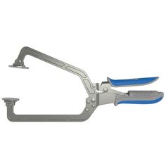 a pair of scissors with blue handles on a white background and clippings attached to the blades