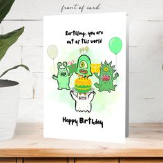 a birthday card with two green monsters holding a cake