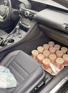 the interior of a car with several cups in it