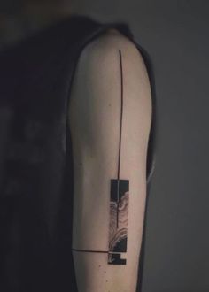 a person with a black and white tattoo on their arm that has an abstract design