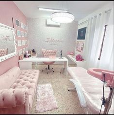 a room with pink furniture and pictures on the wall, including a couch, chair, desk, and mirror