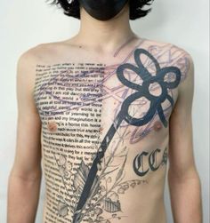 a man with tattoos on his chest and back is holding a scissors in front of him