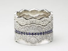 three rings with blue and white diamonds on each one, set in silver plated metal