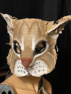 a cat's head is made out of burlap and has been placed on top of a mannequin