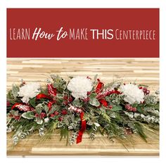 a christmas centerpiece with red and white flowers, greenery and ribbon on it