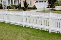 a white picket fence in front of a house