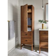 a bathroom with a wooden cabinet next to a sink