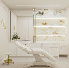 a white chair in the middle of a room with gold trimmings on the walls