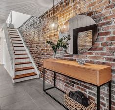 a brick wall with a mirror and some stairs