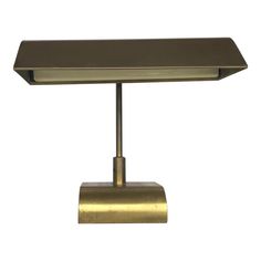 a brass table lamp on a white background