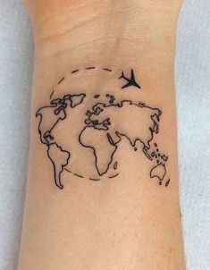 a small wrist tattoo with a world map and birds on the back of its arm