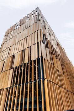 a very tall wooden building with lots of wood slats on it's sides