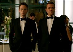 two men in tuxedos standing next to each other