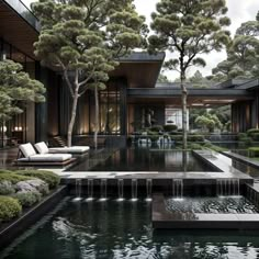 an outdoor pool surrounded by trees and water features a lounge area with two sofas on the other side