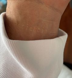 a person's wrist with the word domestic written on it in cursive writing