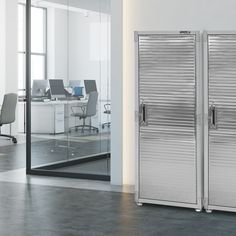 two metal doors are open in an office