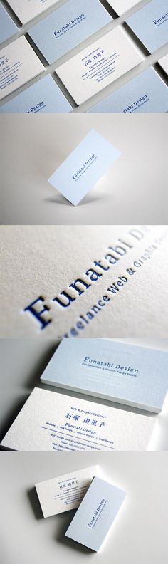 some white and blue business cards on top of each other