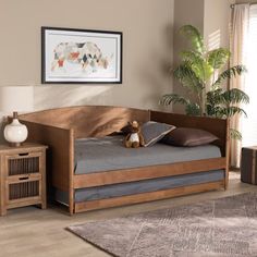 a wooden day bed with a stuffed animal on it