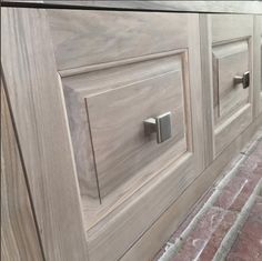 a close up of a wooden cabinet with knobs on the front and back doors