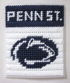 a white and blue woven patch with the word pennell on it's side