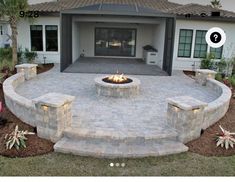 an outdoor fire pit surrounded by stone steps