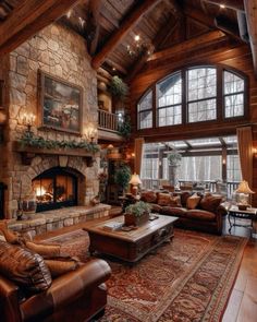 a large living room with stone fireplace and wooden ceiling beams, leather couches and rugs