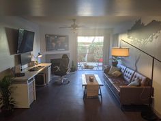 a living room filled with furniture and a flat screen tv