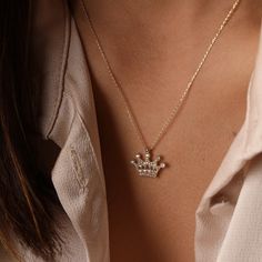 A 14K solid gold crown necklace with delicate CZ accents is a regal and timeless piece of jewelry fit for royalty. Its vintage-inspired design adds a touch of elegance and charm, making it a perfect accessory for any queen or king at heart. As a Mother's Day gift, it symbolizes appreciation for the strength, grace, and leadership that mothers embody every day. It's a thoughtful way to show your love and admiration for the special woman in your life, reminding her that she's truly deserving of th Crown Pendant, King Crown, Crown Necklace, Kings Crown, Solid Gold Chains, Crown Design, Monogram Necklace, Gold Crown, Solid Gold Jewelry