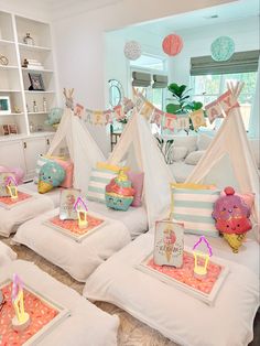 a room filled with lots of toys and tents on top of each other in front of a window