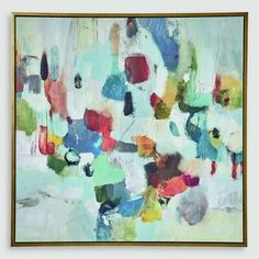 an abstract painting with various colors and shapes on the canvas, framed in gold frame