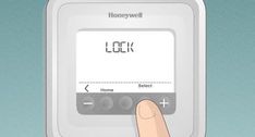 a hand is pressing the button on an electronic device that reads,'lock '