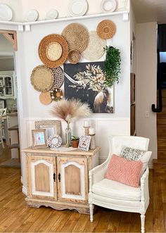 a white chair sitting next to a wooden cabinet on top of a hard wood floor