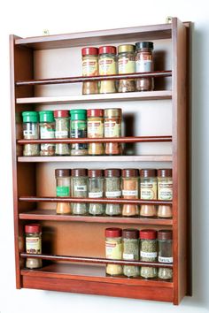 a wooden spice rack filled with lots of spices