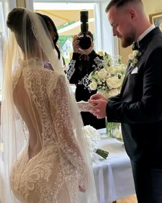 a bride and groom exchanging vows in front of the camera