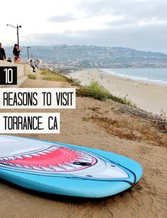 a surfboard sitting on the beach with text overlay that reads 10 best reason to visit torrance ca