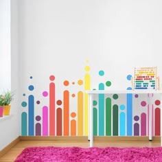 a room with a colorful wall and rug