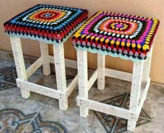 two crocheted stools sitting on top of a tiled floor next to each other