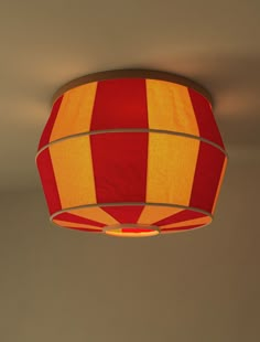 a red and yellow lamp hanging from the ceiling