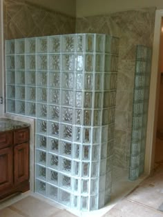 a large glass block shower in a bathroom