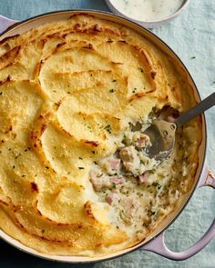 a casserole dish with potatoes and meat in it, ready to be eaten