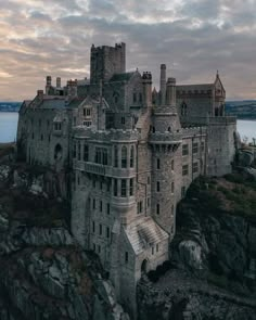 an old castle sitting on top of a cliff