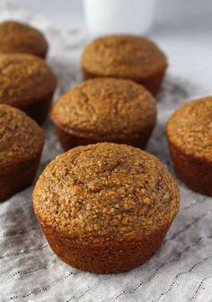 several muffins sitting on top of a white cloth