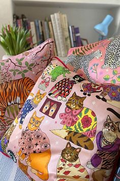 colorful pillows with cats and flowers on them