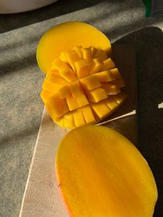 a sliced mango sitting on top of a cutting board