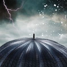 an image of a storm coming in from the sky over a dome with lightning above it