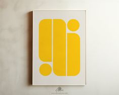 a yellow and white poster with the letter o on it's side hanging on a wall